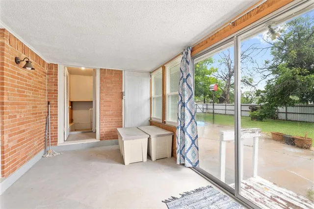 a view of a room with a floor to ceiling window and an outdoor view