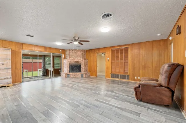a big room with wooden floor and windows