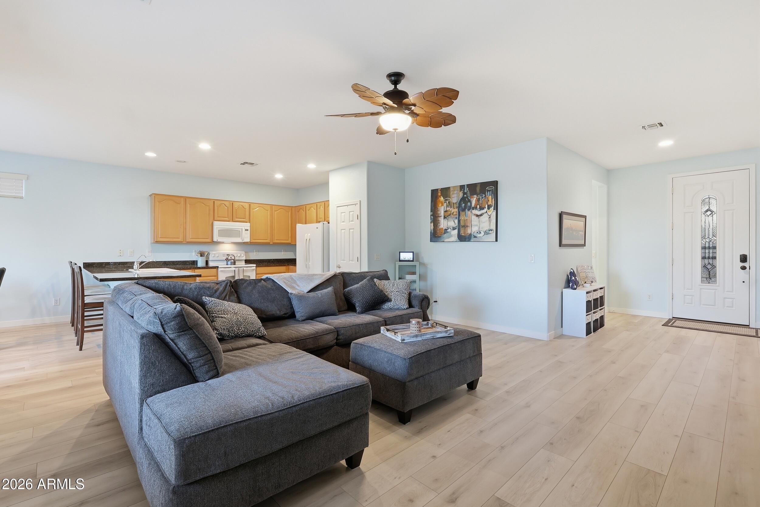 20357 North Lemon Drop Drive Maricopa, AZ 85138 - Photo 11 of 39 a living room with furniture and a ceiling fan