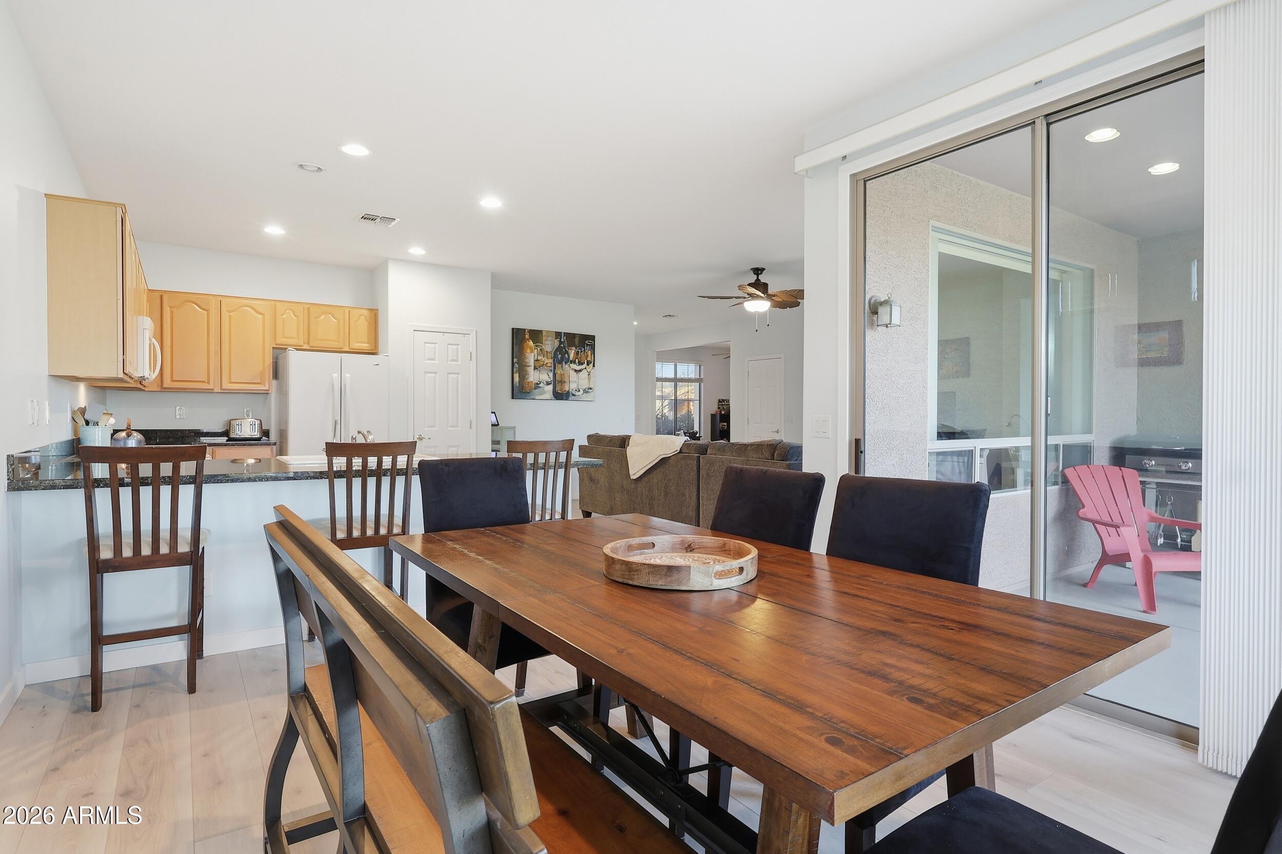 20357 North Lemon Drop Drive Maricopa, AZ 85138 - Photo 13 of 39 a view of a dining room with furniture and wooden floor