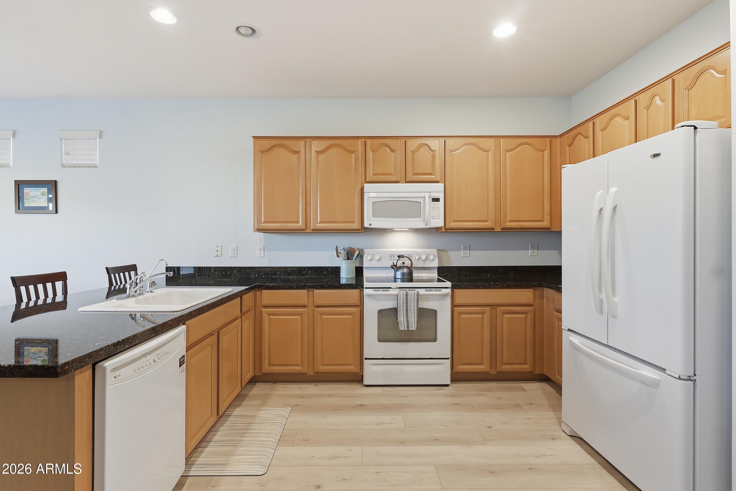 20357 North Lemon Drop Drive Maricopa, AZ 85138 - Photo 16 of 39 a kitchen with stainless steel appliances granite countertop a refrigerator sink and stove