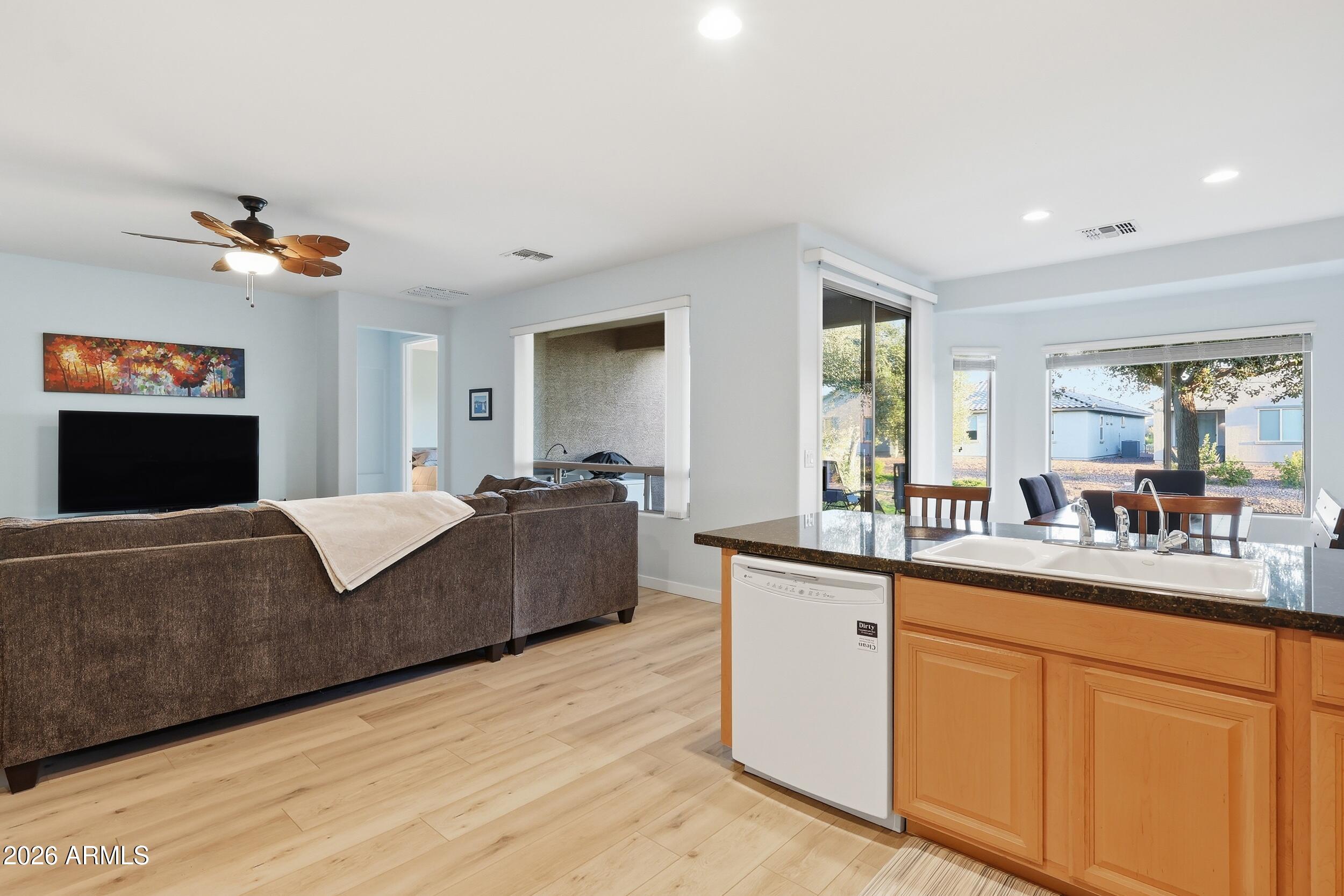 20357 North Lemon Drop Drive Maricopa, AZ 85138 - Photo 17 of 39 a living room with granite countertop furniture and a fireplace