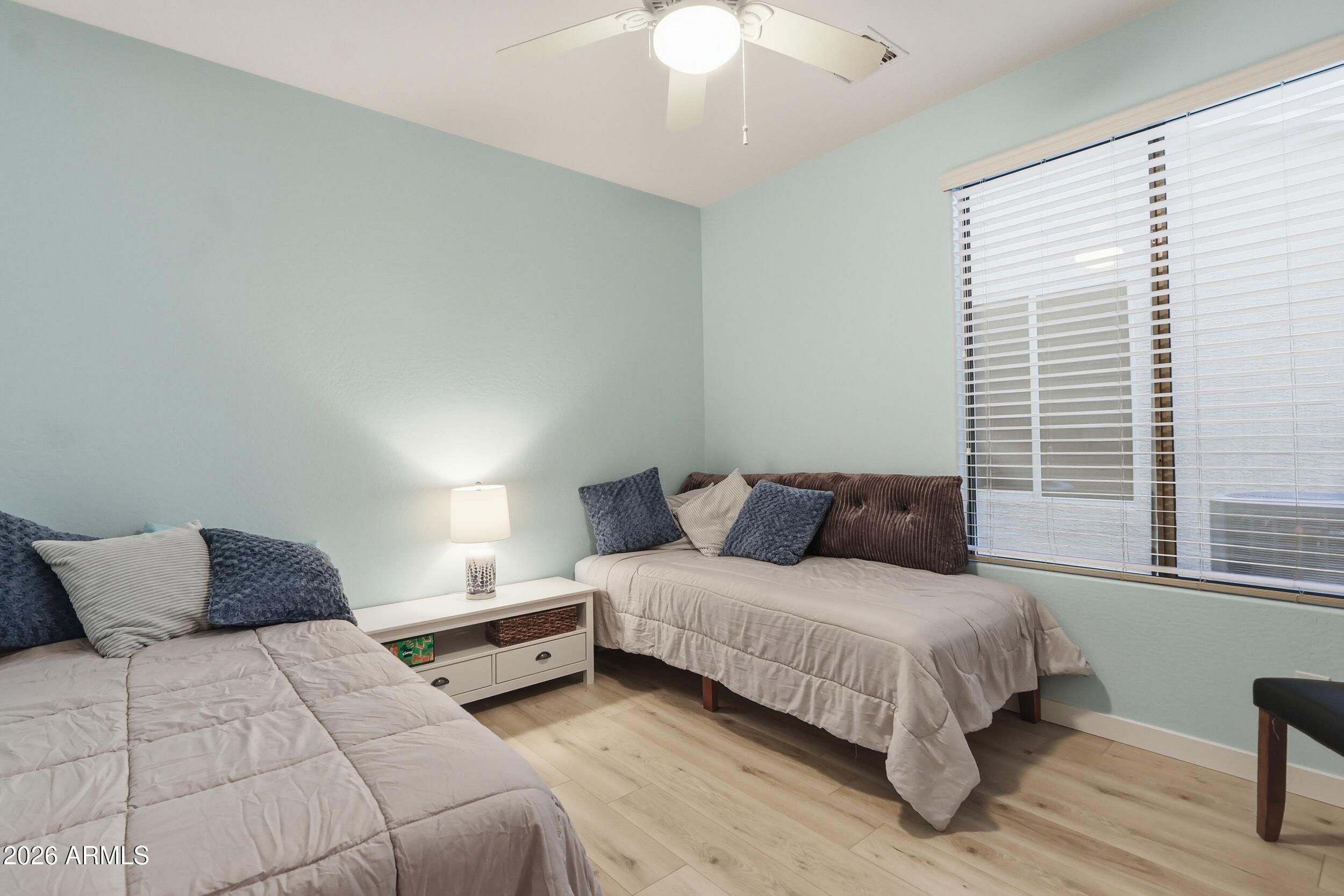 20357 North Lemon Drop Drive Maricopa, AZ 85138 - Photo 19 of 39 a bedroom with bed and a window