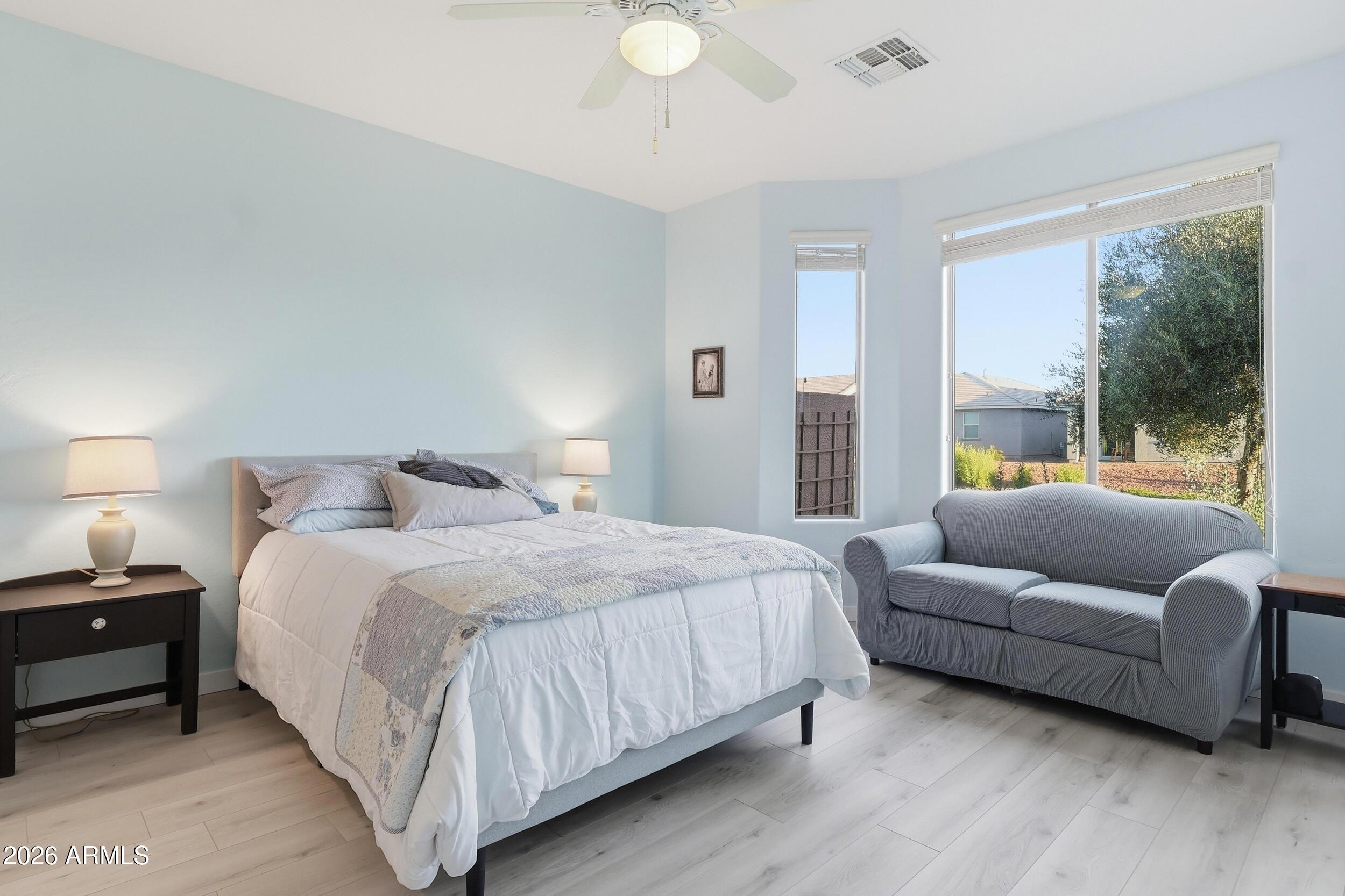 20357 North Lemon Drop Drive Maricopa, AZ 85138 - Photo 23 of 39 a spacious bedroom with a bed and a couch