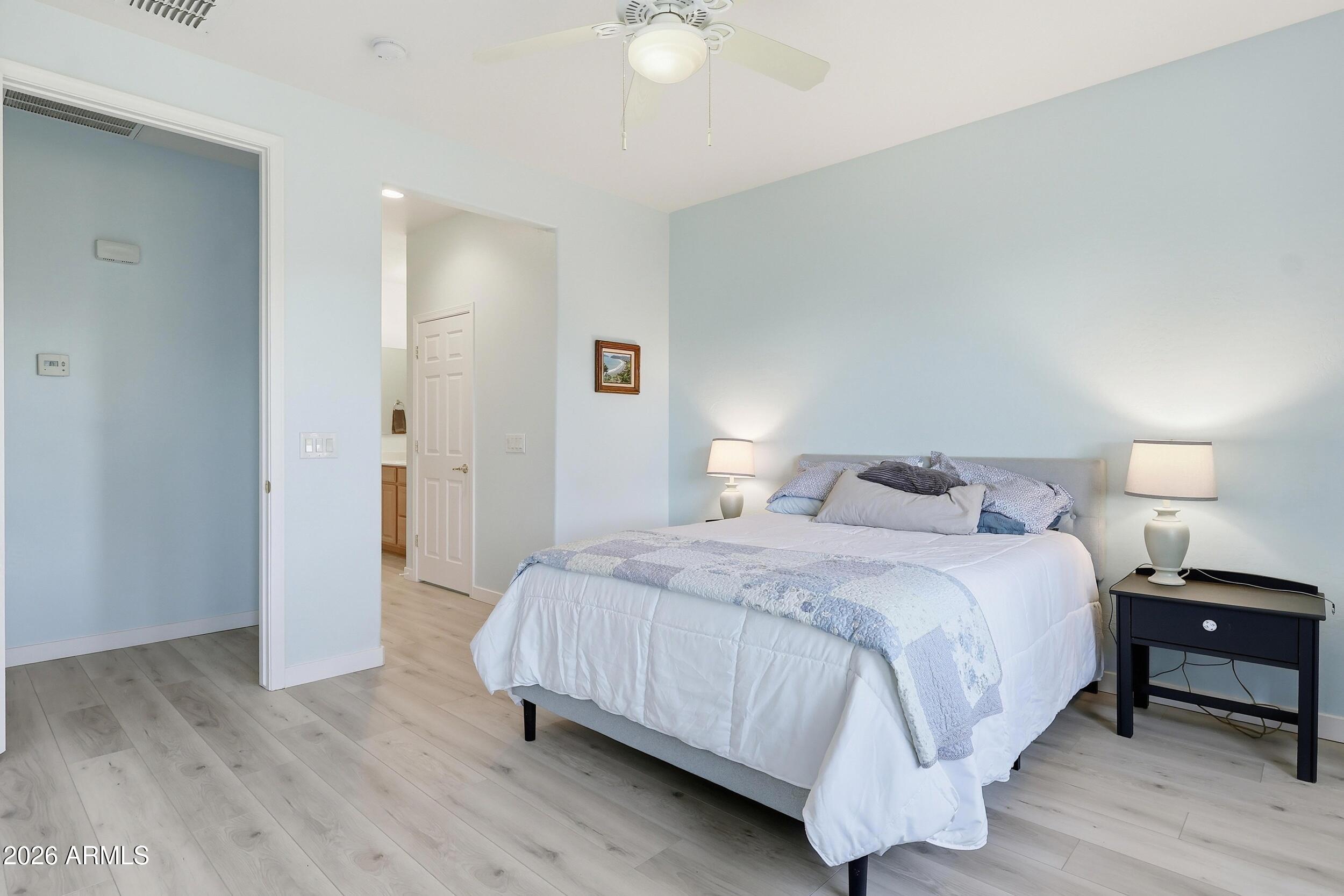 20357 North Lemon Drop Drive Maricopa, AZ 85138 - Photo 24 of 39 a bedroom with a bed and a lamp