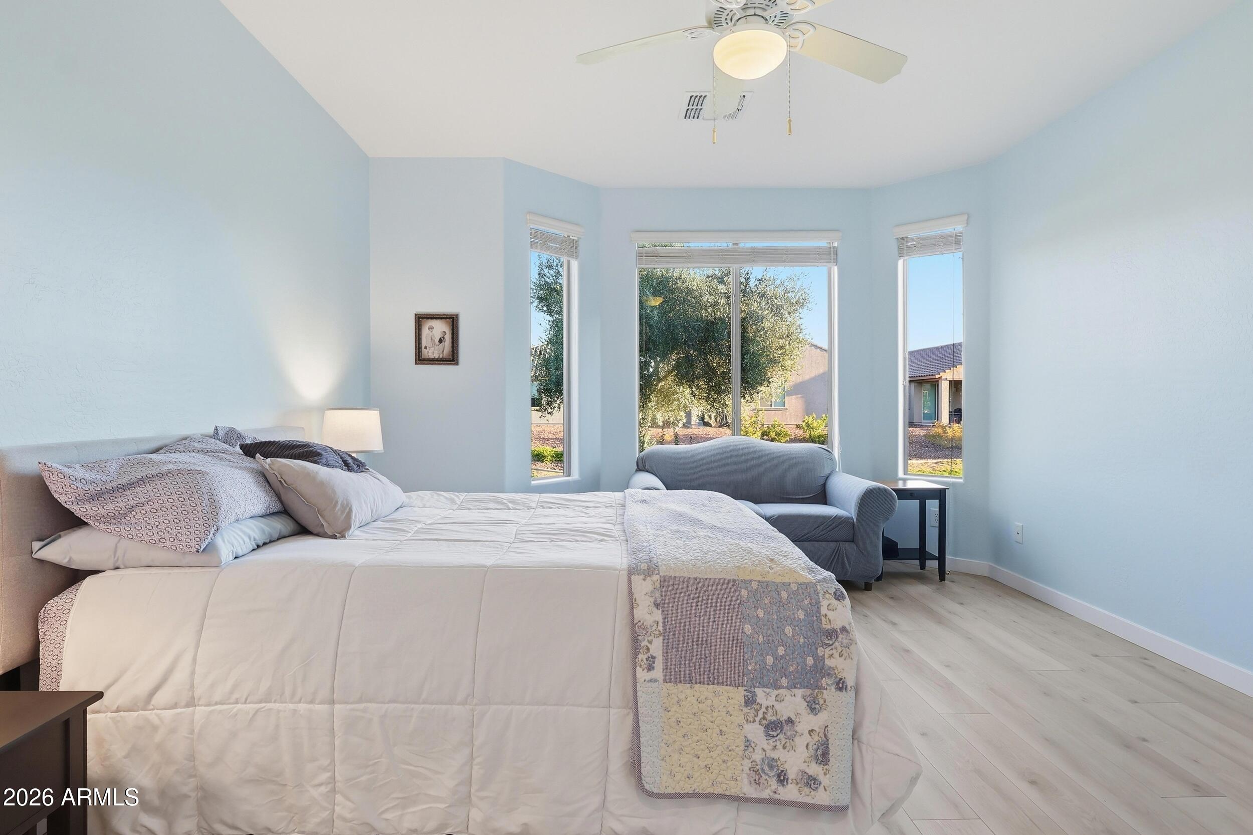 20357 North Lemon Drop Drive Maricopa, AZ 85138 - Photo 25 of 39 a bedroom with a bed and a chandelier