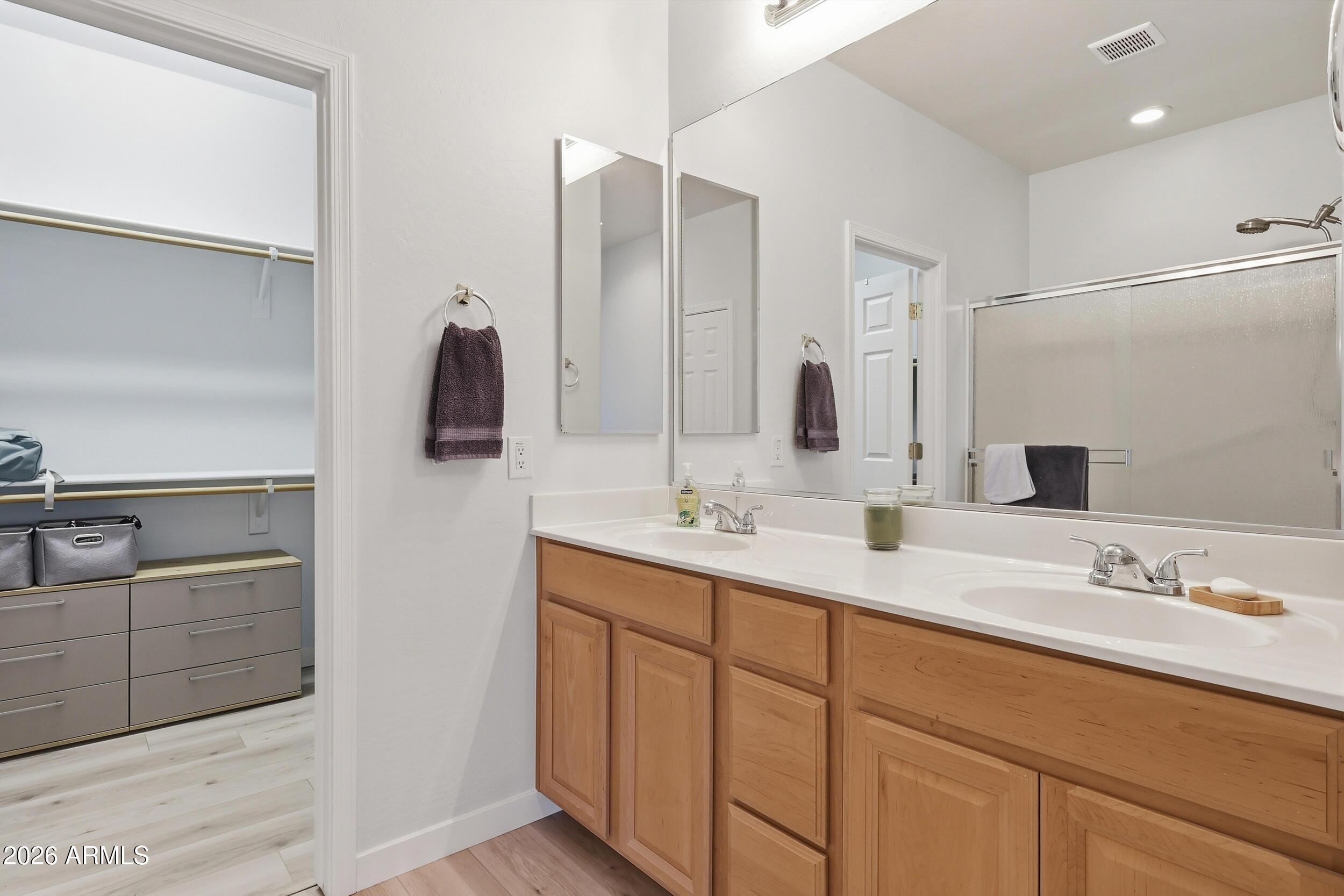 20357 North Lemon Drop Drive Maricopa, AZ 85138 - Photo 26 of 39 a bathroom with a double vanity sink and mirror