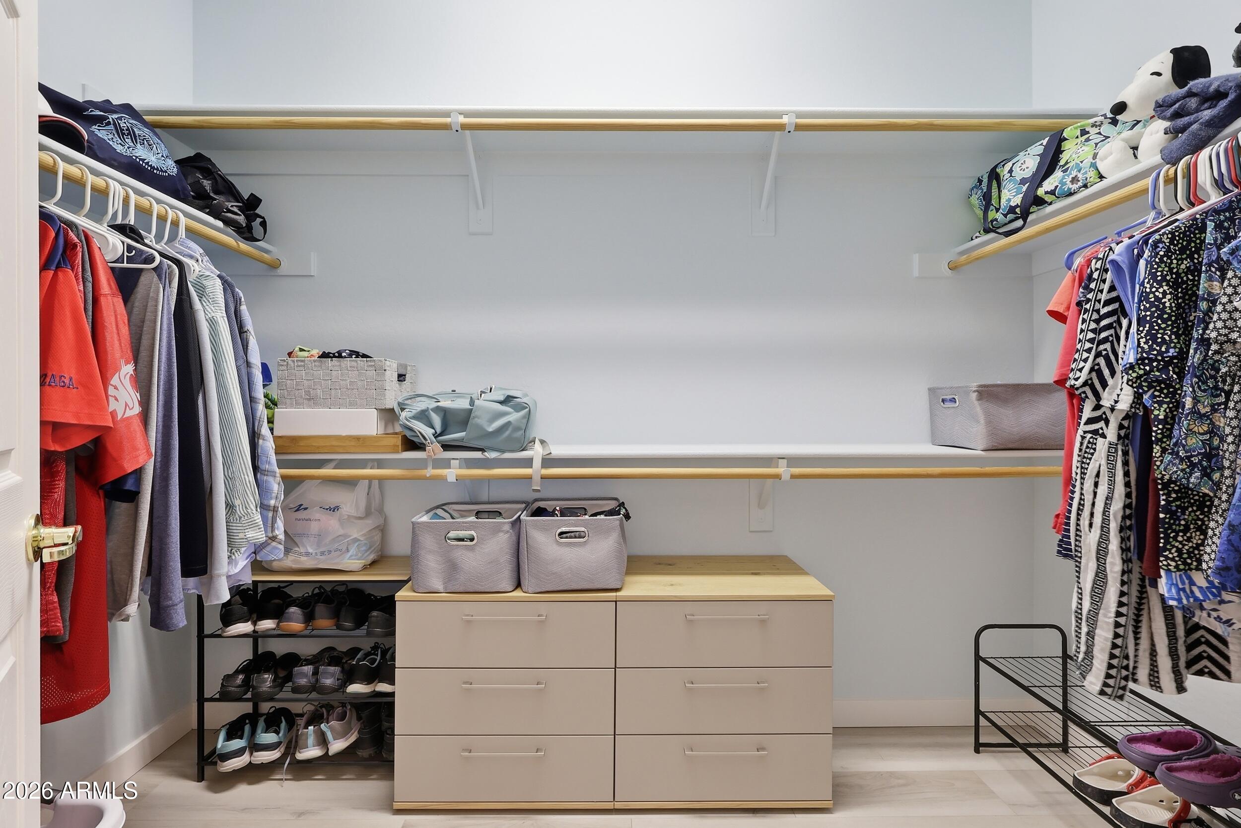 20357 North Lemon Drop Drive Maricopa, AZ 85138 - Photo 27 of 39 a view of walk in closet with clothes and shoes