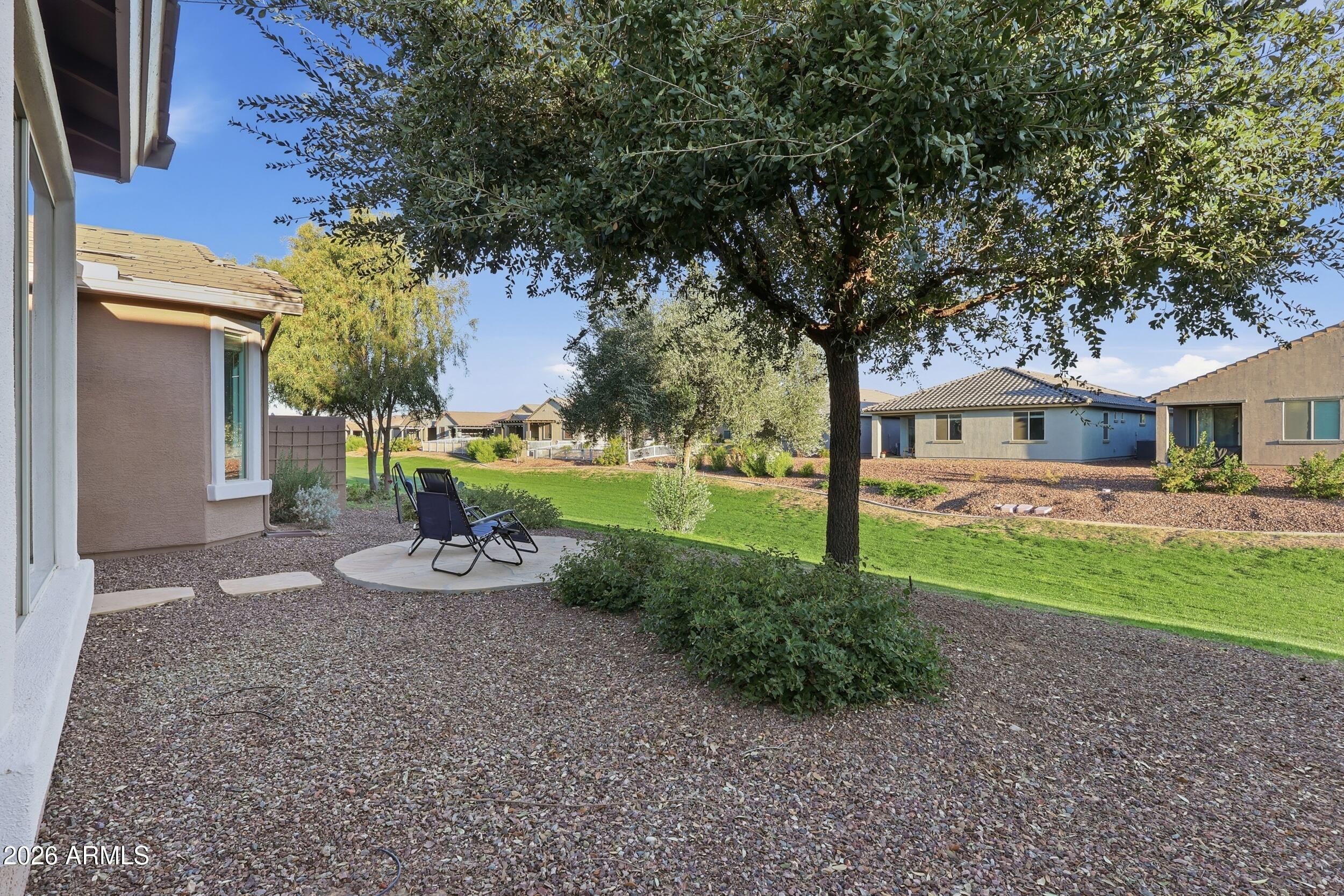 20357 North Lemon Drop Drive Maricopa, AZ 85138 - Photo 28 of 39 a front view of a house with garden and trees