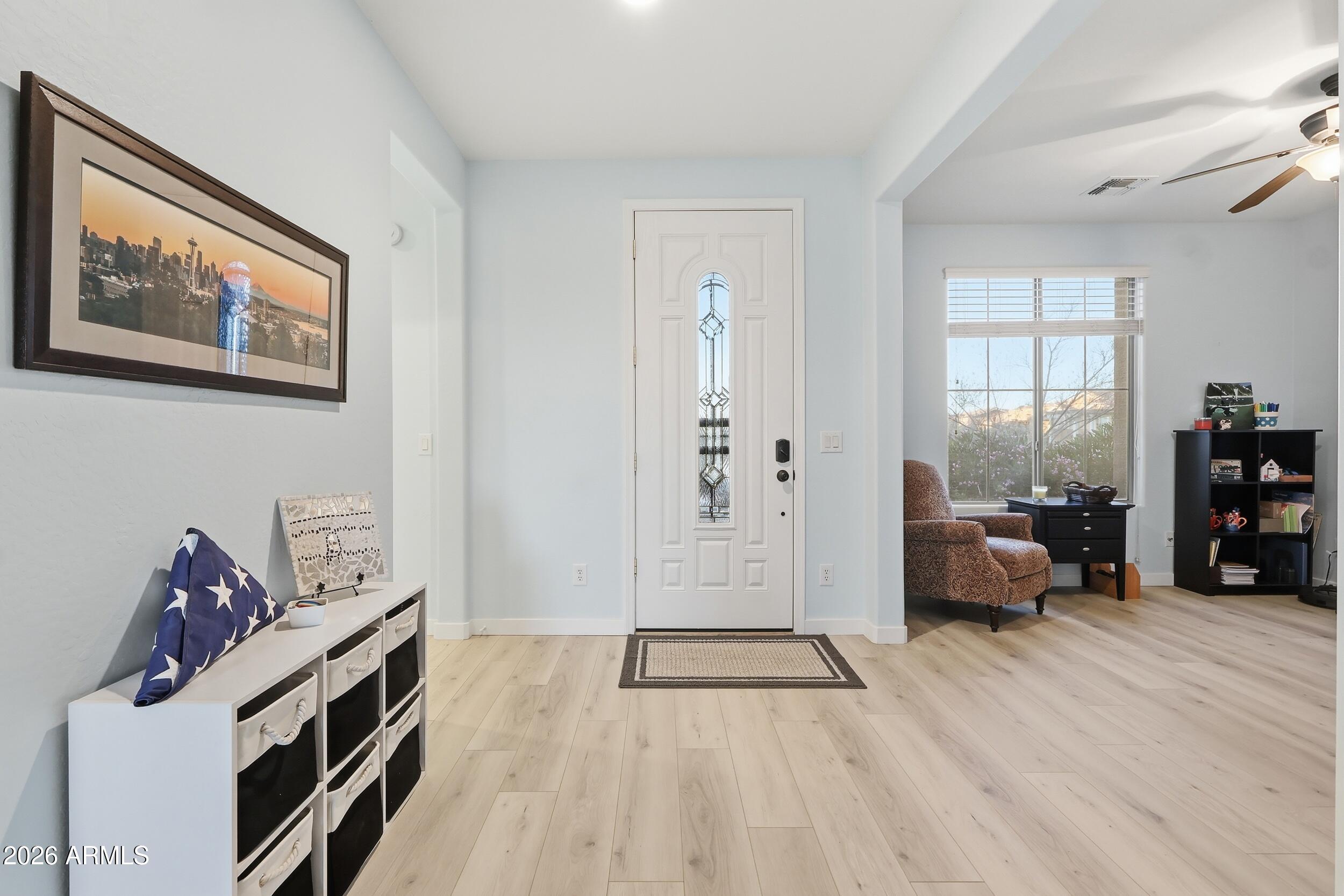 20357 North Lemon Drop Drive Maricopa, AZ 85138 - Photo 5 of 39 a bedroom with furniture and a wooden floor