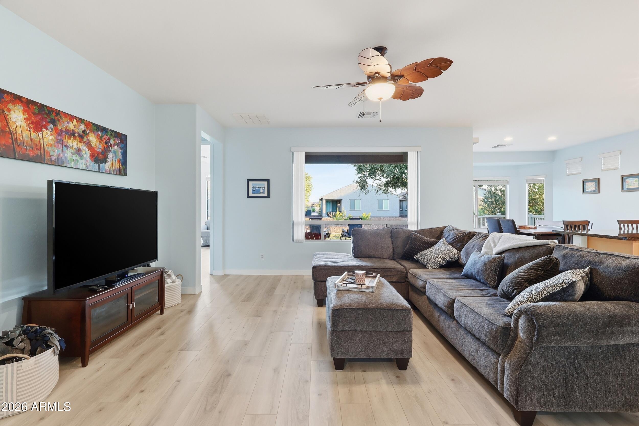 20357 North Lemon Drop Drive Maricopa, AZ 85138 - Photo 7 of 39 a living room with furniture and a flat screen tv