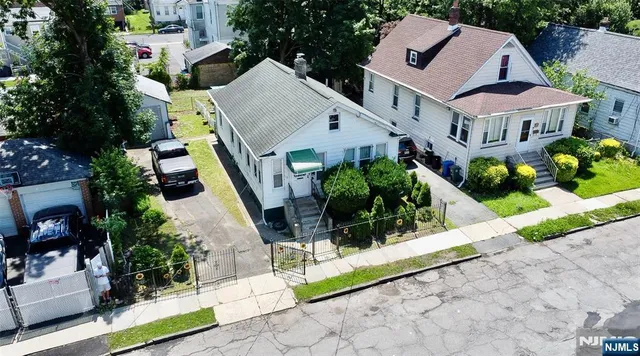 an aerial view of a house with a yard and potted plants