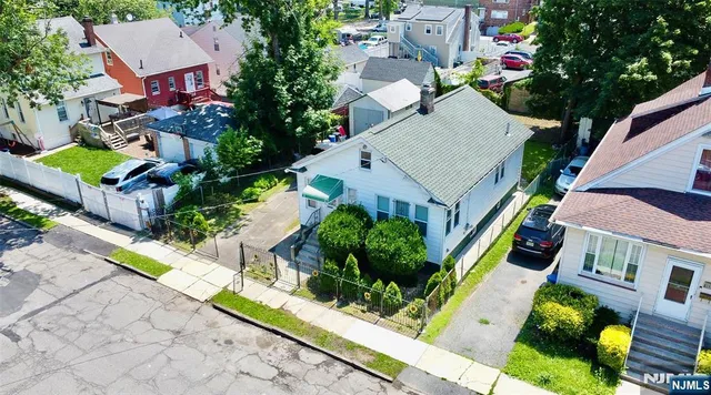 an aerial view of multiple houses with yard