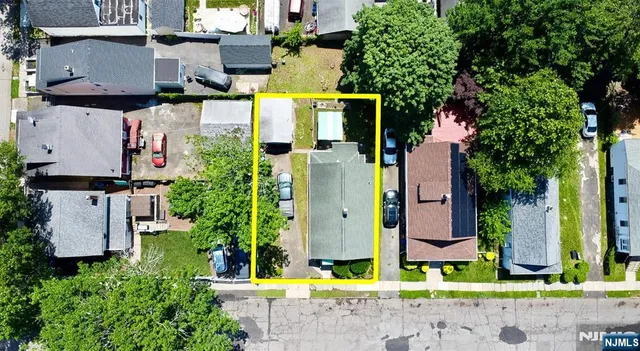 an aerial view of a house with a swimming pool and outdoor seating