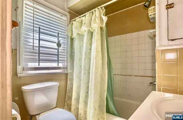 a bathroom with a toilet and shower