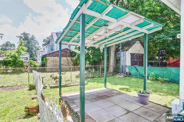 a view of a house with backyard and porch