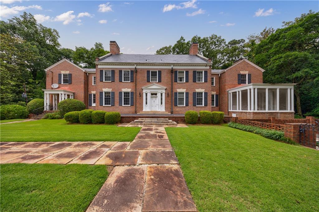 280 Blackland Road Northwest Atlanta, GA 30342 - Photo 14 of 17 a front view of a house with a yard