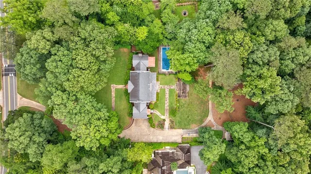 an aerial view of a house with a yard