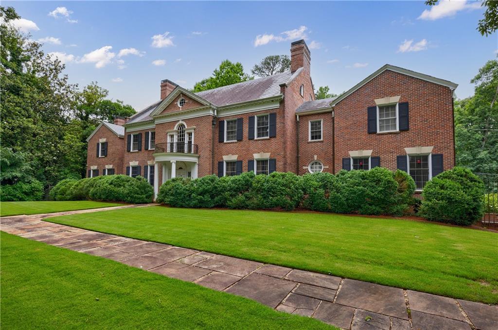 280 Blackland Road Northwest Atlanta, GA 30342 - Photo 2 of 17 a front view of a house with a yard