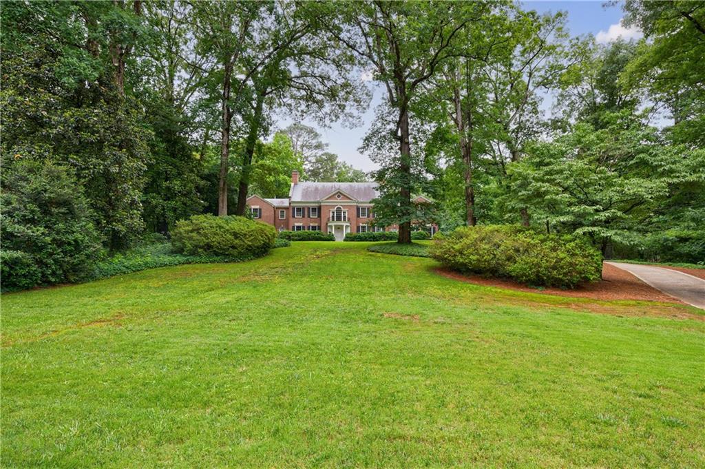 280 Blackland Road Northwest Atlanta, GA 30342 - Photo 4 of 17 a view of a big yard with plants and large trees