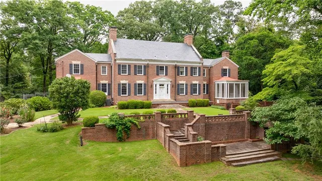 a aerial view of a house with swimming pool and sitting area
