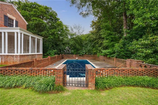 a backyard of a house with a garden and plants