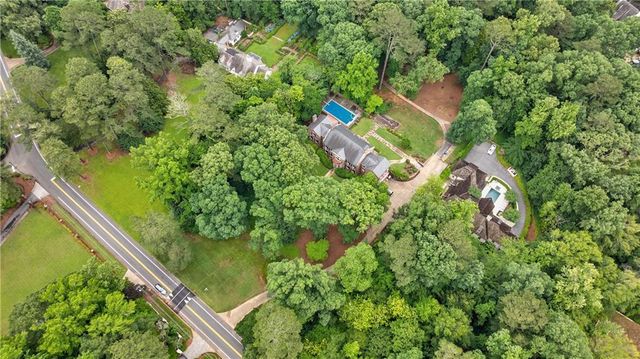 an aerial view of residential house with outdoor space and trees around