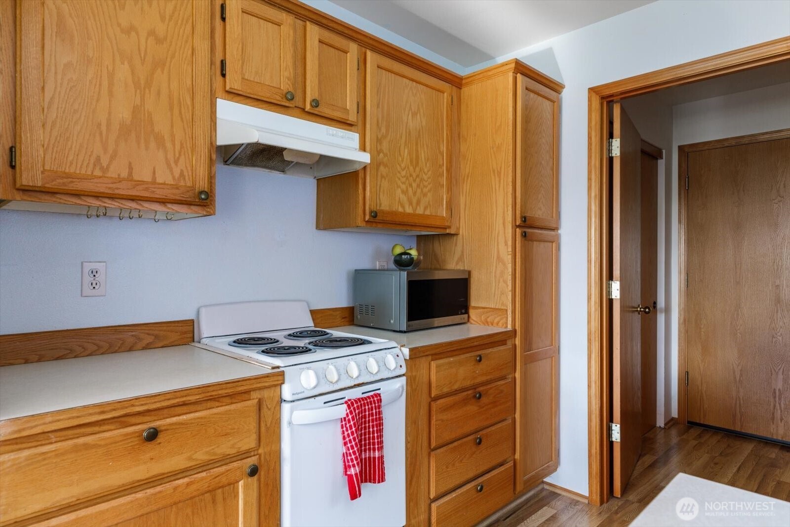 161 West Whidbey Avenue, Unit 5 Oak Harbor, WA 98277 - Photo 20 of 32 a kitchen with stainless steel appliances granite countertop a stove and a microwave