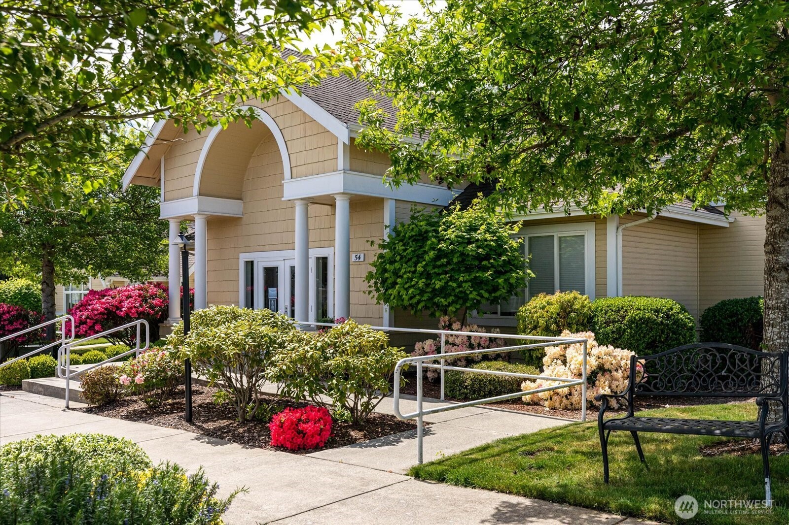 161 West Whidbey Avenue, Unit 5 Oak Harbor, WA 98277 - Photo 27 of 32 a front view of a house with a yard and potted plants