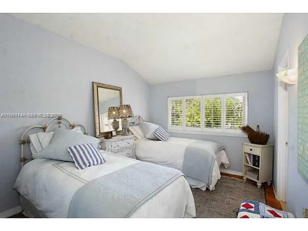 a bedroom with two beds and a window