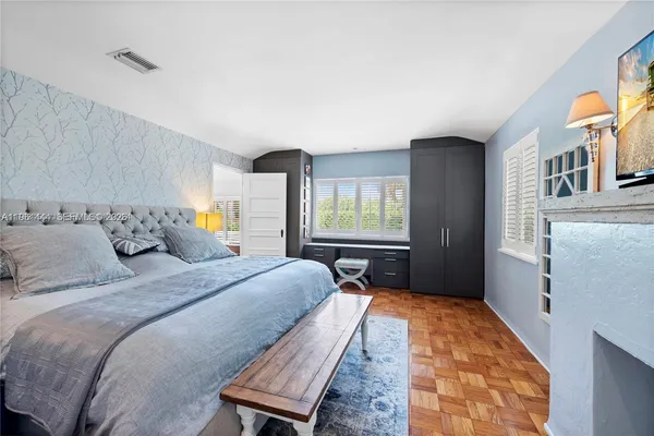 a bedroom with a bed and window