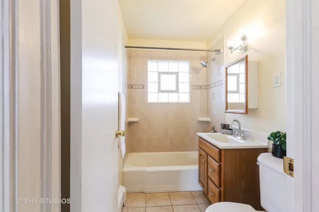 a bathroom with a tub a sink and a mirror