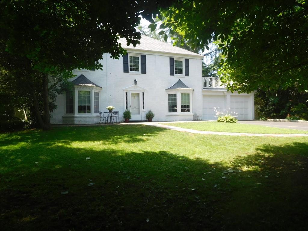 a front view of house with yard and green space