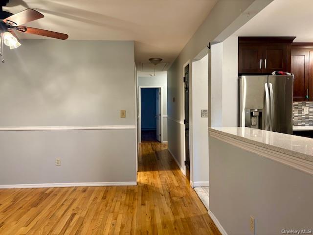 156-40 76th Street, Unit 2 Queens, NY 11414 - Photo 11 of 18 a view of a hallway with wooden floor and a refrigerator
