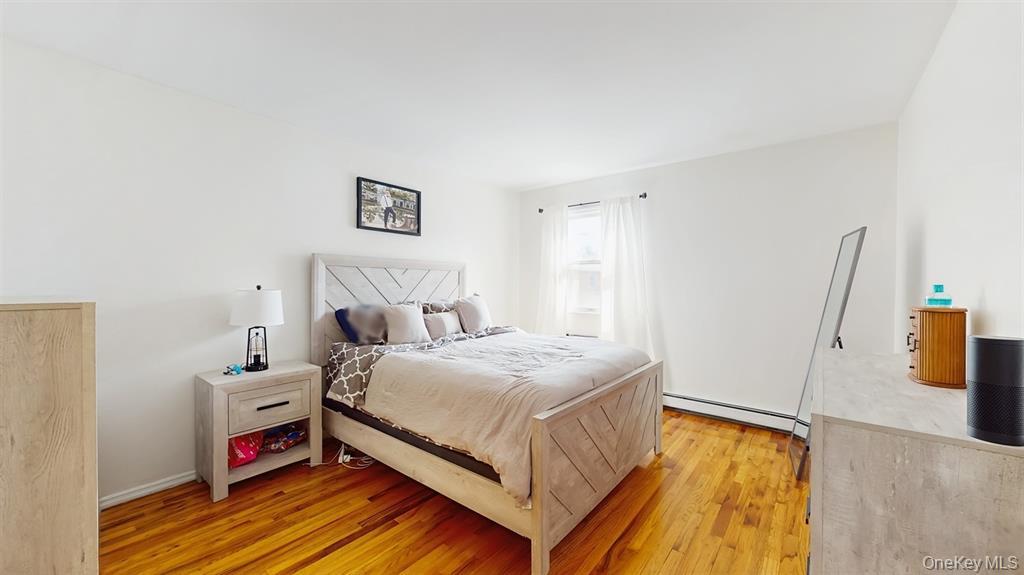 156-40 76th Street, Unit 2 Queens, NY 11414 - Photo 12 of 18 a bedroom with a bed and a flat screen tv