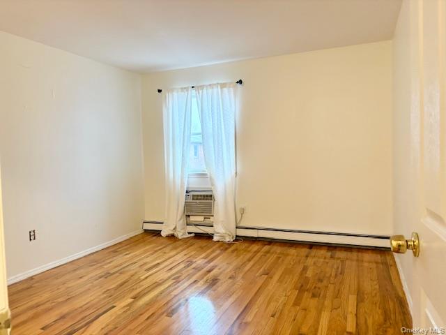 156-40 76th Street, Unit 2 Queens, NY 11414 - Photo 13 of 18 a view of a room with wooden floor and white walls