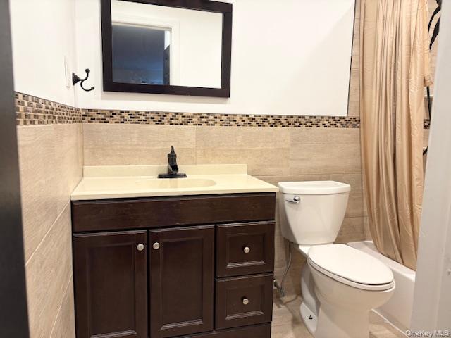 156-40 76th Street, Unit 2 Queens, NY 11414 - Photo 14 of 18 a bathroom with a sink a toilet and mirror