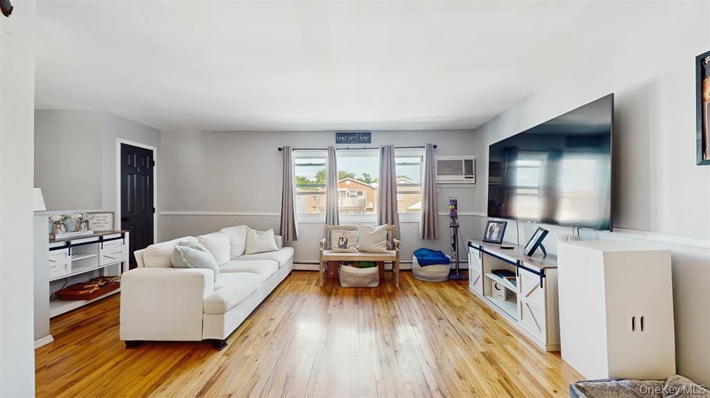 156-40 76th Street, Unit 2 Queens, NY 11414 - Photo 2 of 18 a living room with furniture and a flat screen tv