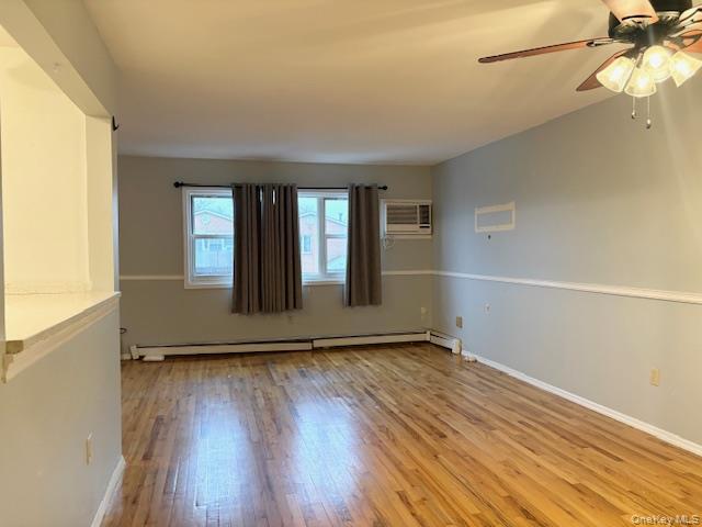 156-40 76th Street, Unit 2 Queens, NY 11414 - Photo 4 of 18 an empty room with wooden floor and windows