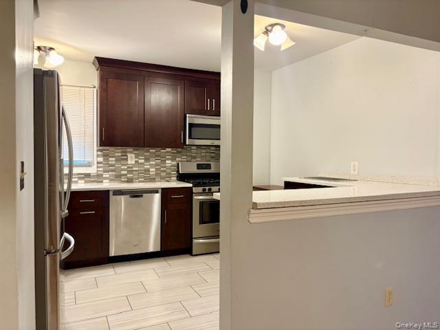 156-40 76th Street, Unit 2 Queens, NY 11414 - Photo 6 of 18 a kitchen with stainless steel appliances granite countertop a refrigerator and a stove