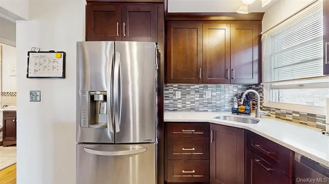a kitchen with a refrigerator and cabinets