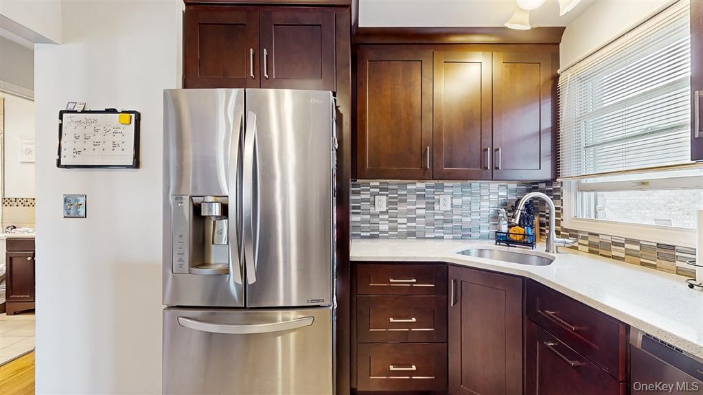 156-40 76th Street, Unit 2 Queens, NY 11414 - Photo 8 of 18 a kitchen with a refrigerator and cabinets
