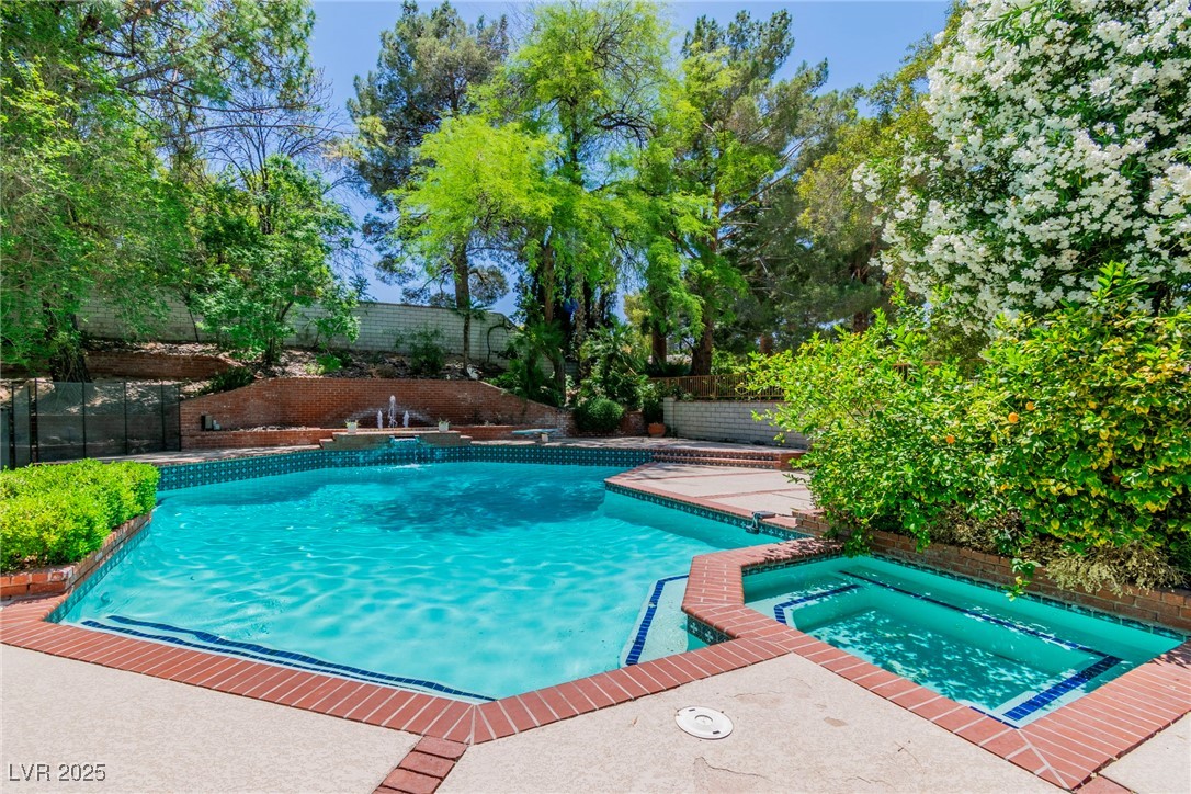 108 Quail Run Road Henderson, NV 89014 - Photo 11 of 50 View of swimming pool featuring a fenced backyard, a patio area, and a pool with connected hot tub