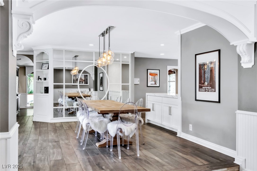 108 Quail Run Road Henderson, NV 89014 - Photo 24 of 50 Dining space with arched walkways, dark wood finished floors, and a chandelier