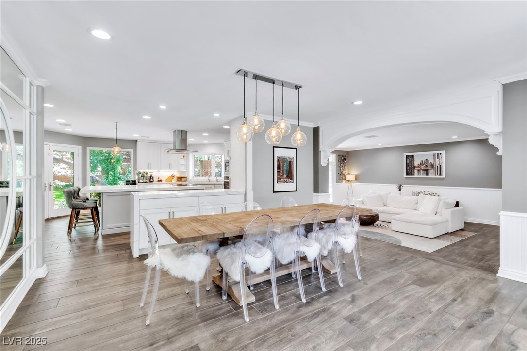 108 Quail Run Road Henderson, NV 89014 - Photo 25 of 50 Dining room featuring light wood-style floors, healthy amount of natural light, a wainscoted wall, and recessed lighting