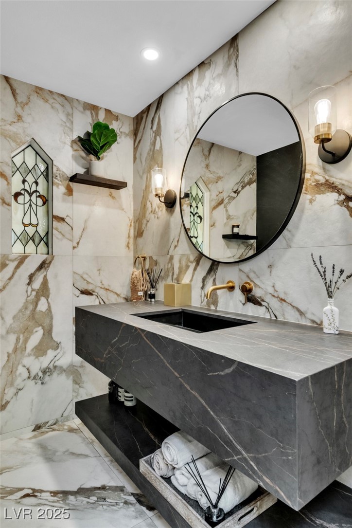 108 Quail Run Road Henderson, NV 89014 - Photo 3 of 50 Bathroom with marble tiled flooring, stone wall, recessed lighting, tile walls, and vanity