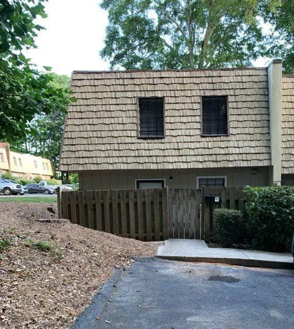 a view of a house with a backyard