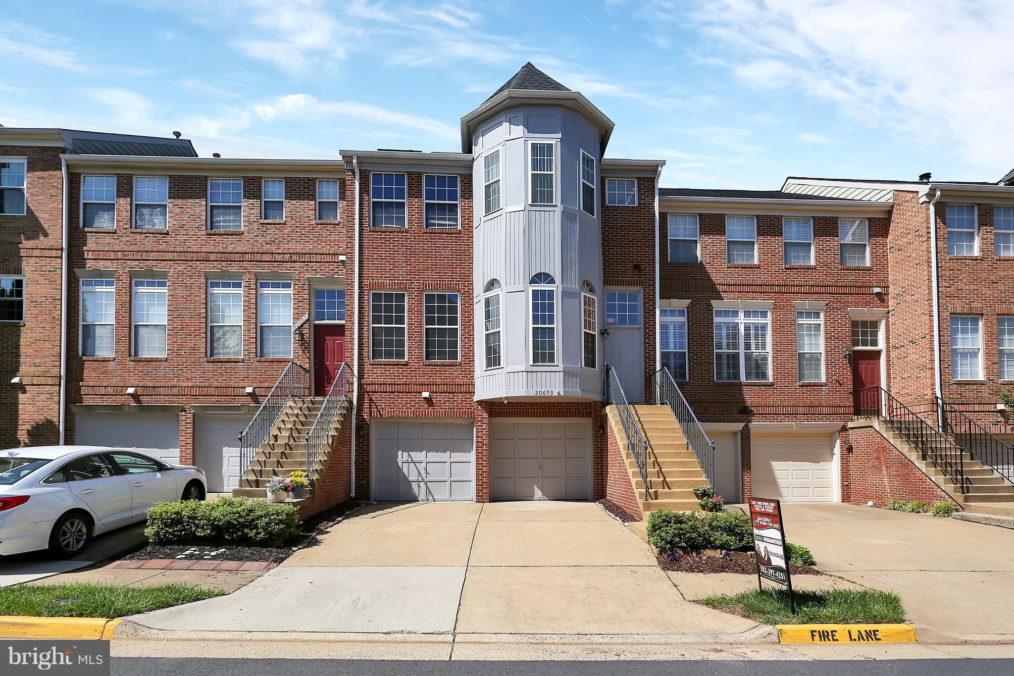 20693 Riptide Square Sterling, VA 20165 - Photo 1 of 30 a front view of a residential apartment building with a yard