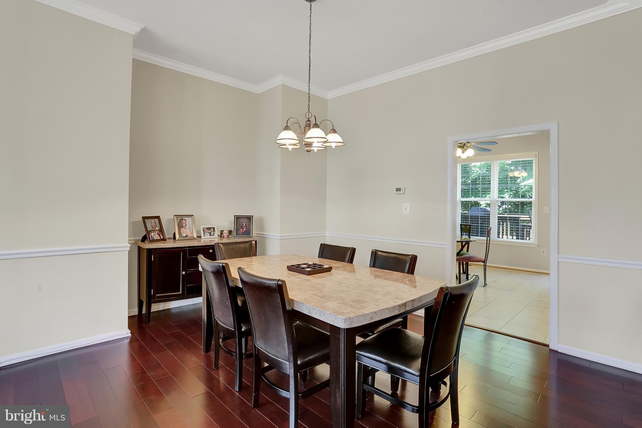 20693 Riptide Square Sterling, VA 20165 - Photo 12 of 30 a view of a dining room with a table and chairs
