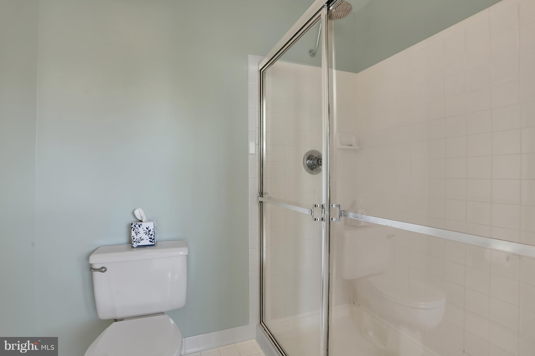 20693 Riptide Square Sterling, VA 20165 - Photo 18 of 30 a bathroom that has a toilet a sink and shower